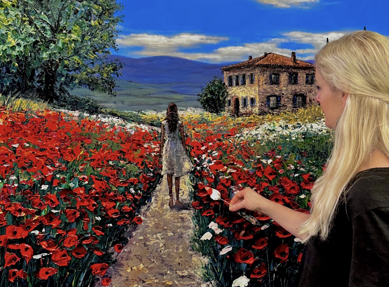 Jennifer Vranes in the studio holding a palette knife with red paint beside an impasto landscape