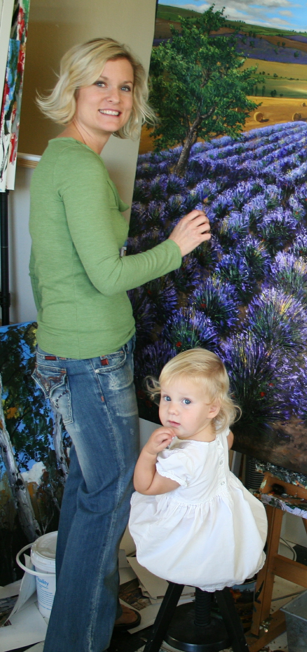Jennifer Vranes in her studio at work on a lavender field painting